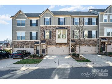 Three-story townhome with two-car garage and neutral color scheme at 1907 Catkin Ln, Charlotte, NC 28205