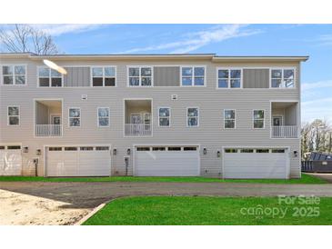 Three-story townhome with attached garage and small yard at 3713 Lou Ann Ave, Charlotte, NC 28208