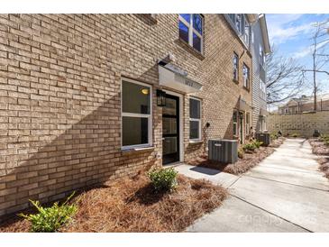 Charming brick townhouse with a well-maintained walkway and landscaping at 3713 Lou Ann Ave, Charlotte, NC 28208