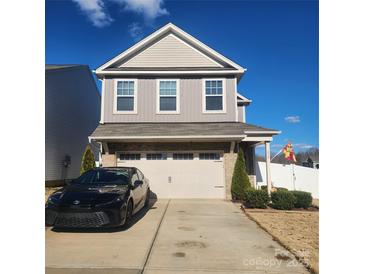 Two-story house with gray siding, two-car garage, and a landscaped front yard at 612 Spencer Ln, Kannapolis, NC 28081