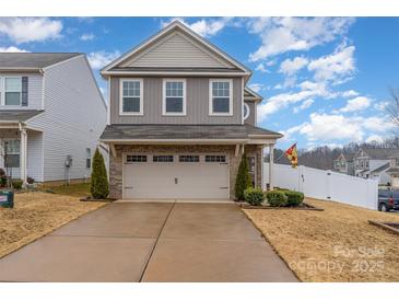 Two-story home with gray siding, brick accents, and a two-car garage at 612 Spencer Ln, Kannapolis, NC 28081