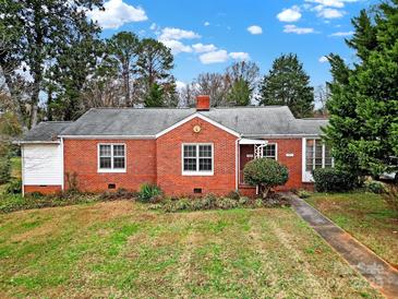 Brick ranch home with a well-manicured lawn at 951 Cedar St, Rock Hill, SC 29730