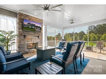 Cozy screened porch with fireplace and comfortable seating at 11112 Benjamin Smith Ave, Huntersville, NC 28078