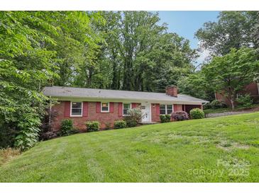 Charming brick home featuring a lush green lawn and inviting curb appeal at 132 30Th Nw Ave, Hickory, NC 28601