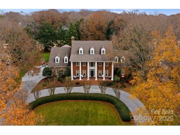 Impressive two-story home with circular driveway and landscaped lawn at 5401 Sunningdale Dr, Charlotte, NC 28277