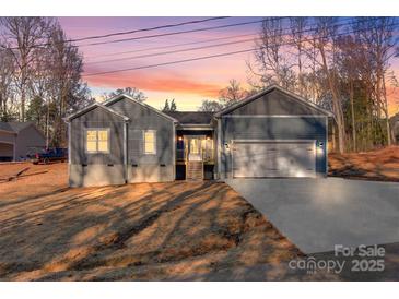 Newly constructed home with gray siding, two-car garage, and landscaped yard at 9181 Cherokee Dr, Hickory, NC 28601