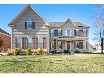 Two-story house with brown shutters and a large front yard at 9729 Capella Nw Ave, Concord, NC 28027