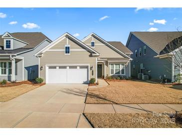 Charming one-story home with a two-car garage and well-manicured lawn at 1025 Lake Como Dr, Monroe, NC 28110