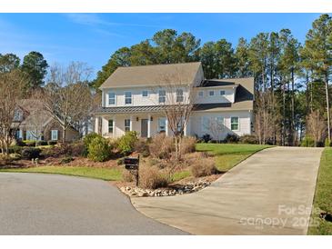 Two-story home with white siding, gray door, and a long driveway at 116 Cedar Branch Ct, Mooresville, NC 28117