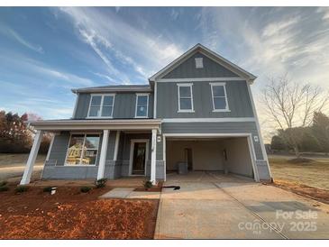 Charming two-story home featuring a welcoming porch and an attached two-car garage at 1305 39Th Avenue Ne Pl, Hickory, NC 28601