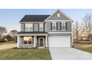 Charming two-story home with a gray exterior, a two-car garage and well-manicured lawn at 1305 39Th Avenue Ne Pl, Hickory, NC 28601