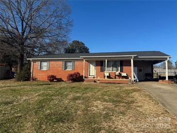 Brick ranch home with carport and landscaped yard at 1710 Patrick Ave, Shelby, NC 28152