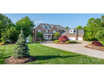 Stunning brick home with lush landscaping, circular driveway, and attached three-car garage at 4165 54Th Ne Ave, Hickory, NC 28601