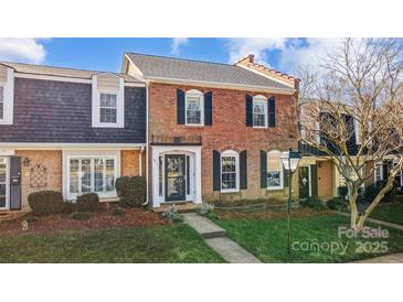 Brick front townhouse with a charming, landscaped yard at 4413 Simsbury Rd, Charlotte, NC 28226