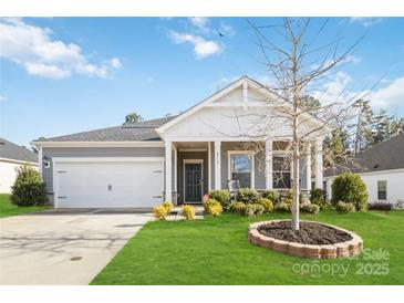 Gray house with white accents, front porch, and landscaping at 8715 Pennegrove Cir, Charlotte, NC 28214