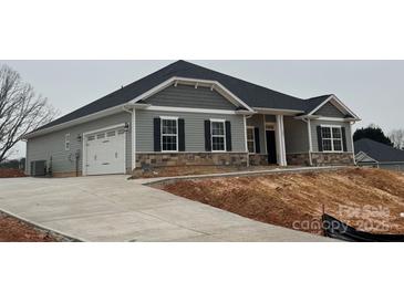 Gray siding house with stone accents and a two-car garage at 104 Kerr Walk Dr # 14, Statesville, NC 28677