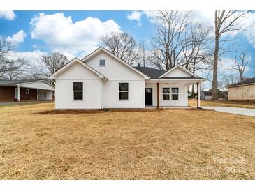 Charming white home with dark trim, manicured lawn, and inviting front porch at 1200-1 Stanton Dr, Shelby, NC