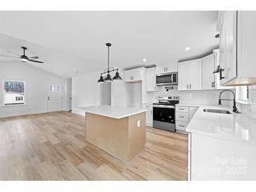 Bright kitchen boasts white cabinets, stainless steel appliances, and a large center island at 1200-1 Stanton Dr, Shelby, NC