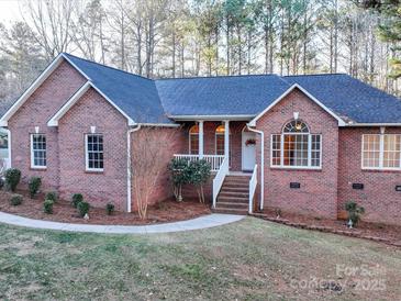 Brick house with a gray roof, and a walkway leading to the front entrance at 121 Sierra Woods Dr, Troutman, NC 28166