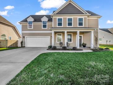 Two-story house with a front porch and attached garage, landscaped lawn at 228 Pinnacle Xing, Shelby, NC 28152