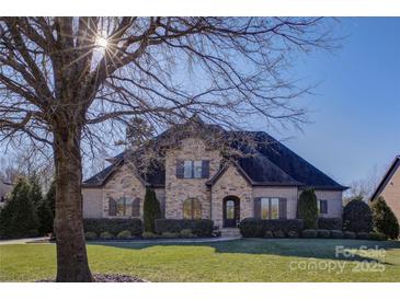 Beautiful two-story home with stone accents and a manicured lawn at 4010 Soleado Dr, Matthews, NC 28104