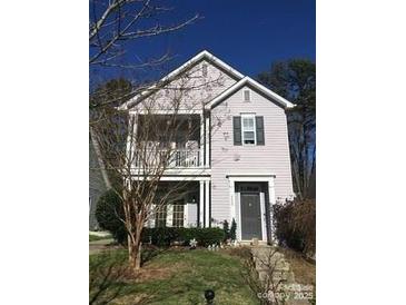 Charming two-story home with gray door and small balcony at 4827 Eaves Ln, Charlotte, NC 28215