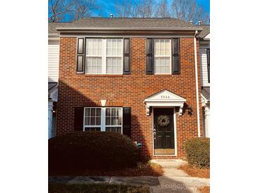 Brick front exterior of charming townhome with landscaping at 8044 Sapwood Ct, Matthews, NC 28104