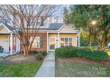 Inviting exterior of charming brick home with well-manicured landscaping at 8146 Rudolph Rd, Charlotte, NC 28216