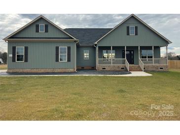 Charming home featuring a covered porch, complemented by dark shutters and a well-manicured lawn at 226 Beths Ct, York, SC 29745