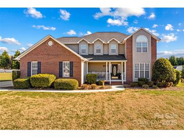 Brick two-story house with a large front yard and landscaping at 415 Cameron Dr, Salisbury, NC 28147