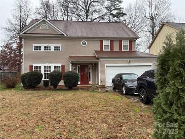 Two-story house with a neutral exterior, attached garage, and well-maintained lawn at 9624 Langston Mill Rd, Charlotte, NC 28216