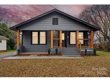 Charming gray house with wood accents and landscaped yard at 4421 Gum St, Charlotte, NC 28208