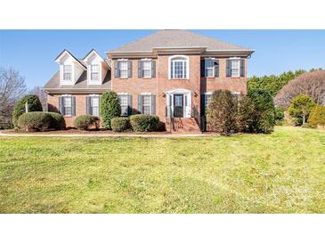 Brick two-story house with a large front yard and mature landscaping at 5023 Ancestry Cir, Matthews, NC 28104