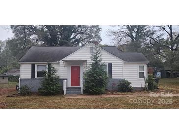 Charming white house with red door, gray brick base, and landscaping at 5917 Peach St, Charlotte, NC 28269