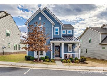 Two-story home with blue siding, metal roof, and front porch at 6142 Cloverdale Dr, Tega Cay, SC 29708