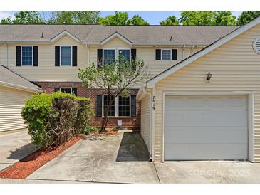 Inviting townhome featuring a well-kept lawn and attached one car garage at 7019 Walnut Ridge Ct, Charlotte, NC 28217
