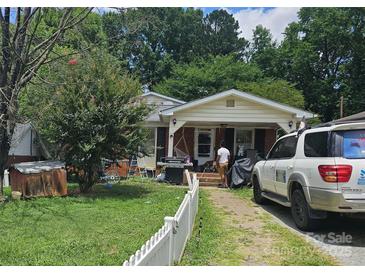 House exterior with a yard, white picket fence, and driveway at 800 Thera Dr, Charlotte, NC 28206