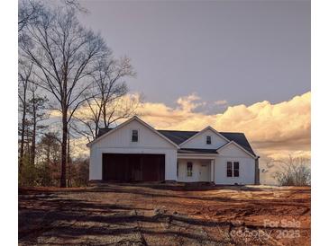 White farmhouse exterior with a two-car garage at 9062 Mccray Farms Dr, Hickory, NC 28601