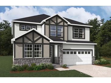 Two-story house with gray and white exterior, stone accents, and a three-car garage at 9957 Cask Way, Huntersville, NC 28078