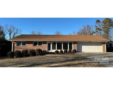 Brick ranch house with attached garage and landscaping at 108 Greenview Dr, Kannapolis, NC 28081