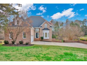 Brick house with a two-car garage and a well-manicured lawn at 13833 Jonathans Ridge Rd, Mint Hill, NC 28227