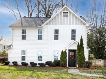 Charming two-story home featuring a black front door and a well-manicured lawn at 1509 B Briar Creek Rd, Charlotte, NC 28205