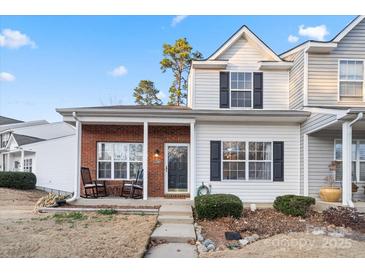 Inviting brick and white two-story townhome with rocking chairs on front porch at 1550 Maypine Commons Way, Rock Hill, SC 29732