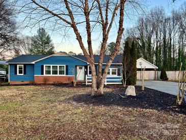 Charming ranch home with blue siding, brick accents, and a landscaped lawn at 235 Linda St, Salisbury, NC 28146