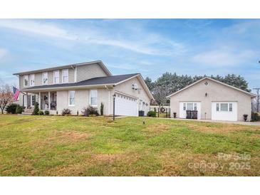 Two-story house with attached garage and separate outbuilding, nicely landscaped yard at 4105 South Fork Ave, Hickory, NC 28602