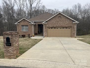 Brick ranch house with attached garage and landscaped yard at 506 Birmingham Ct, Rock Hill, SC 29732