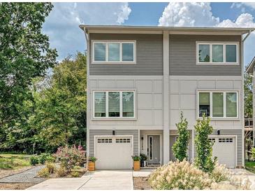 Modern two-story home with gray siding, attached garage, and landscaped front yard at 7324 Swans Run Rd, Charlotte, NC 28226