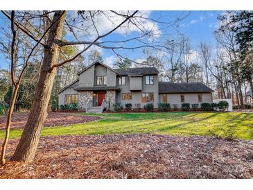 Two-story house with stone accents and a landscaped lawn at 9435 Squirrel Hollow Ln, Charlotte, NC 28720