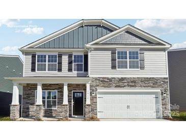 Charming two-story home featuring stone accents, black shutters, and a two-car garage at 11127 Cardinal Creek Ave, Charlotte, NC 28215