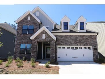 Charming two-story home with a beautiful stone facade and a white garage door, offering a blend of modern and traditional design at 1136 Yellow Springs Dr, Huntersville, NC 28078